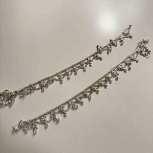 Pair of silver anklets from Bangladesh with floral design.